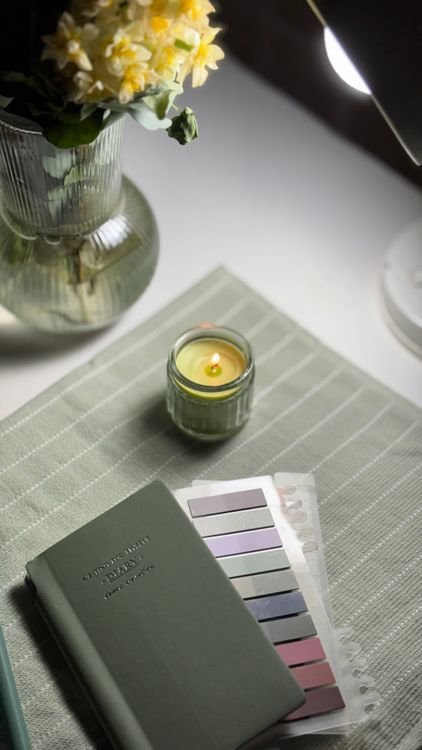 Cozy journal and candle for an evening wind-down routine