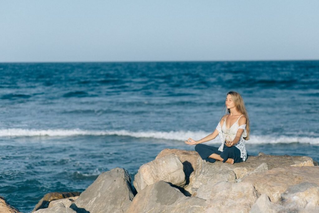 Woman meditating near sea calm and peaceful