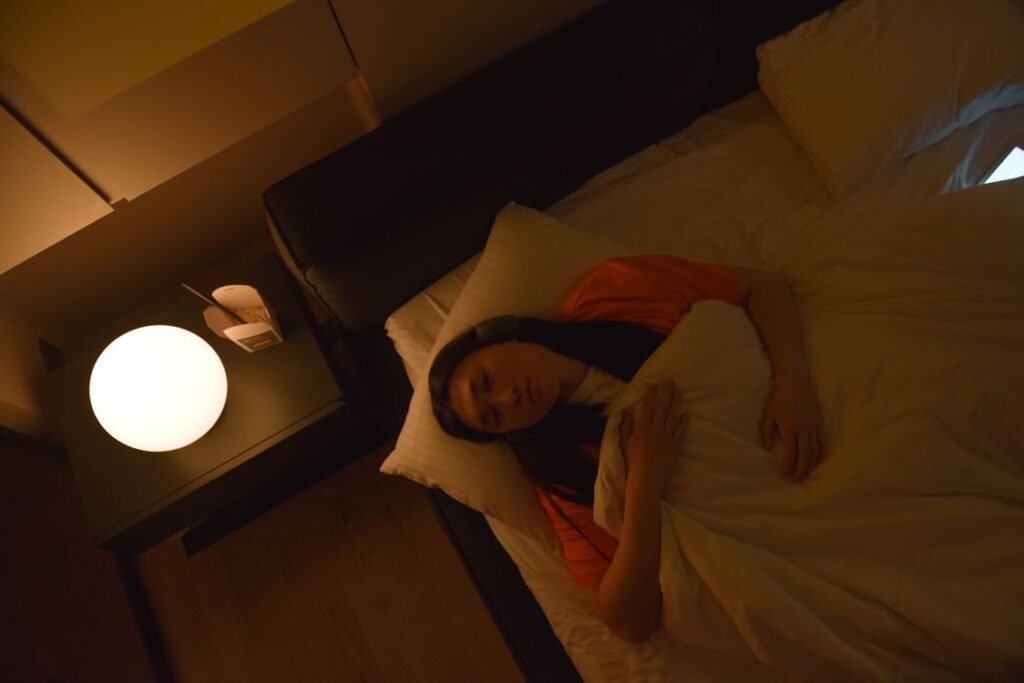 Woman awake lying in bed unable to sleep at night